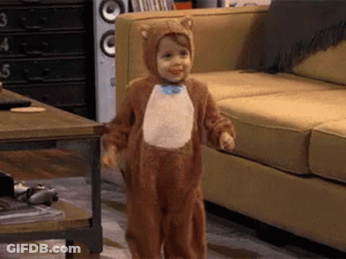 Little Boy In Bear Costume Standing In Living Room GIF