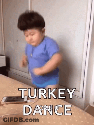 Little Boy In Blue Shirt Dancing On Bed Next To Phone GIF