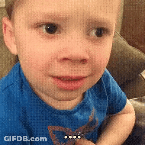 Little Boy In Blue Shirt Making Funny Face GIF