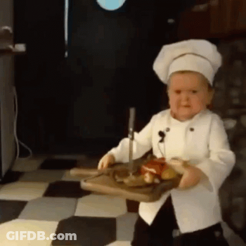 Little Boy In Chef Hat Holding Cutting Board With Meat GIF