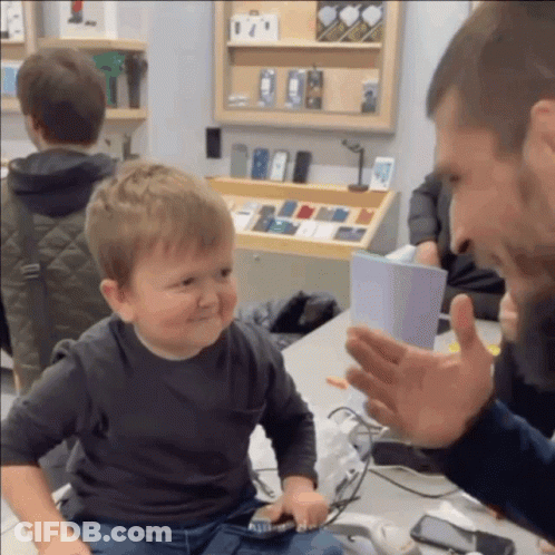 Little Boy In Front Of Phone Display GIF