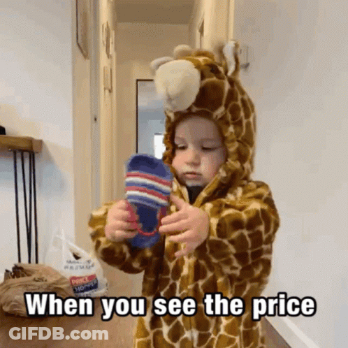 Little Boy In Giraffe Costume Holding Socks GIF