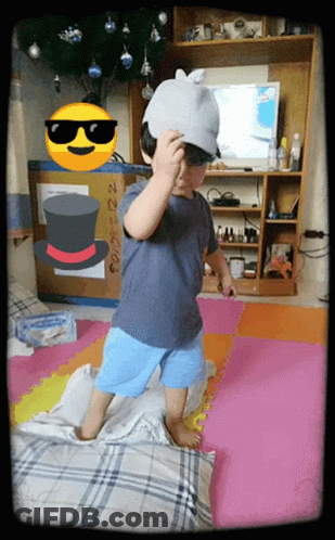 Little Boy In Hat And Sunglasses On Pillow GIF