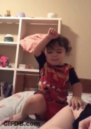 Little Boy In Lightning McQueen Shirt Sitting On Bed GIF