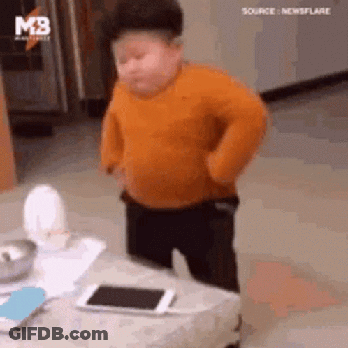 Little Boy In Orange Sweater With Cell Phone GIF