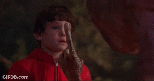 Little Boy In Red Jacket Looking At Alien With Light GIF