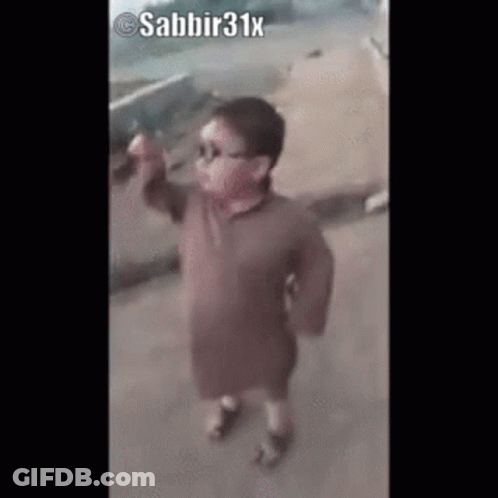 Little Boy In Sunglasses And Brown Shirt On Sidewalk GIF