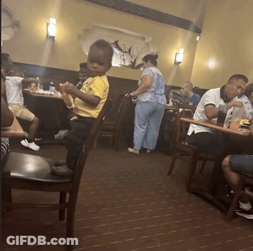 Little Boy In Yellow Shirt In Restaurant GIF