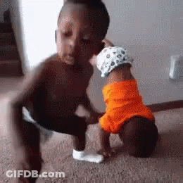Little Boy Kissing Baby In Orange Shirt GIF