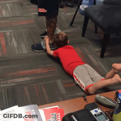 Little Boy Laying On Floor With Mississippi Football Flyer GIF