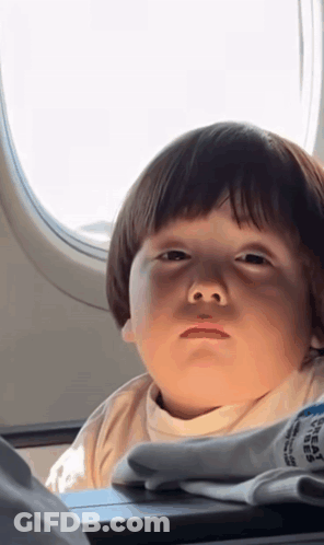 Little Boy Looking Out Airplane Window GIF