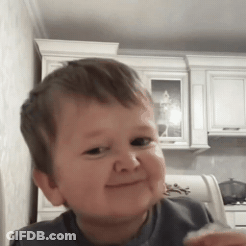 Little Boy Making Funny Face Holding Food GIF
