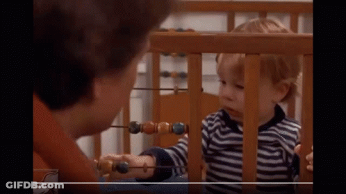 Little Boy Playing With Abacus While Woman Looks On GIF