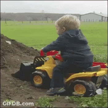 Little Boy Riding Toy Truck GIF
