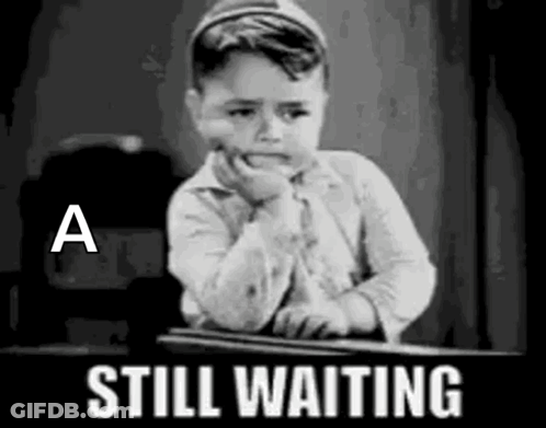 Little Boy Sitting At Desk Waiting GIF