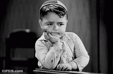 Little Boy Sitting At Desk With Hand On Chin Sad GIF