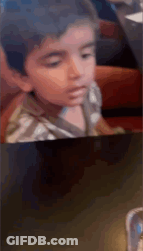 Little Boy Sitting At Table GIF