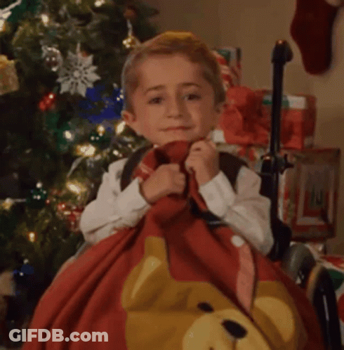 Little Boy Sitting By Christmas Tree Holding Teddy Bear Blanket GIF