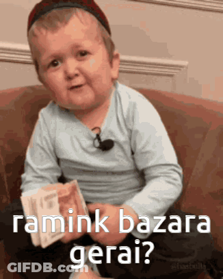 Little Boy Sitting On Couch Holding Money Asking Ramink Bazara Gerai GIF