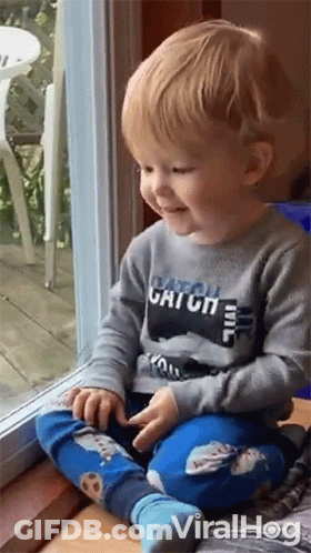 Little Boy Sitting On Window Sill Smiling GIF