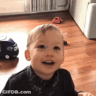 Little Boy Sitting On Wooden Floor With Toy Car GIF