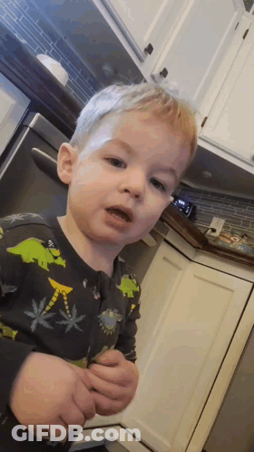 Little Boy Standing In Dinosaur Pajamas GIF