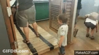 Little Boy Standing Next To Woman And Man GIF