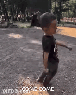 Little Boy Walking Down Dirt Road Holding Stick GIF