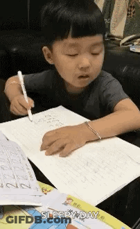 Little Boy Writing In Notebook GIF