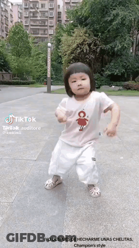 Little Girl Dancing On Sidewalk With TikTok Logo GIF
