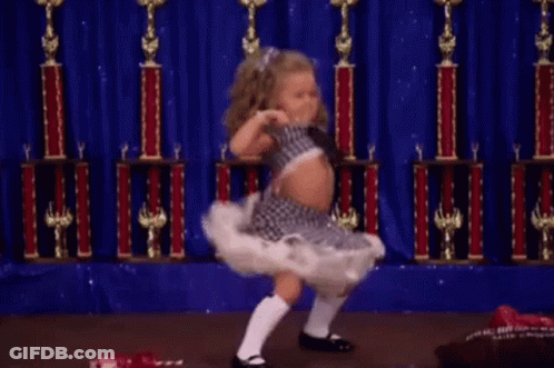 Little Girl Dancing On Stage With Trophies GIF