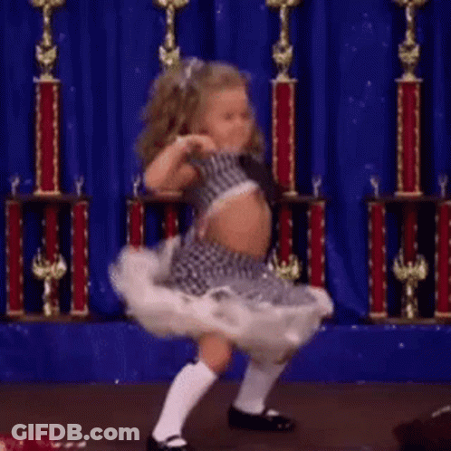 Little Girl Dancing With Trophies On Stage GIF