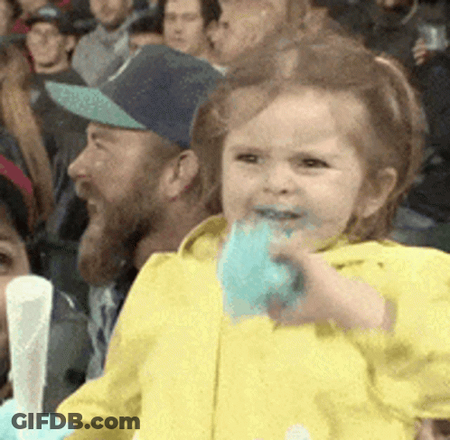 Little Girl Eating Cotton Candy In Stadium GIF