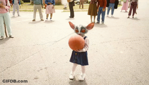 Little Girl Holding Basketball In Front Of Crowd GIF