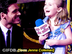 Little Girl Holding Microphone Talking To Man In Suit And Tie GIF