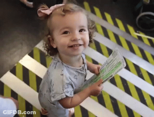 Little Girl Holding Passport On Striped Floor GIF