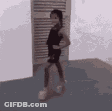 Little Girl In Black Dress And White Shoes At Door GIF