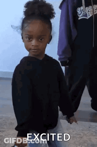 Little Girl In Black Sweater Holding Water Making Funny Face GIF