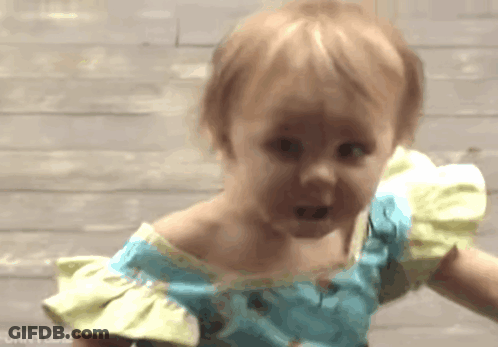 Little Girl In Blue And Yellow Dress Making A Face GIF