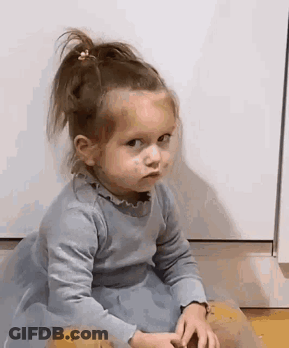 Little Girl In Blue Dress Making Face GIF