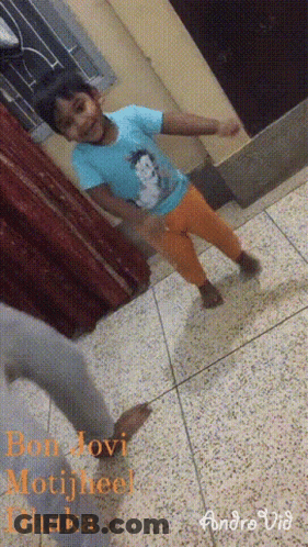 Little Girl In Blue Shirt And Orange Pants Dancing GIF