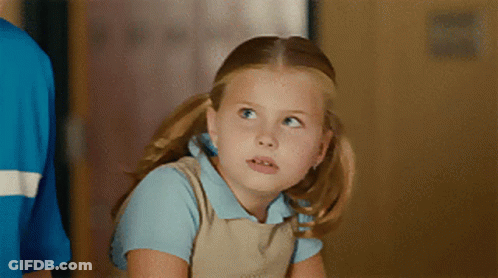 Little Girl In Blue Shirt And Tan Overalls Looking Up GIF