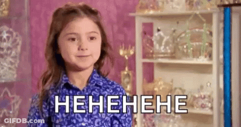 Little Girl In Blue Shirt Laughing In Pink Room GIF