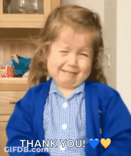 Little Girl In Blue Sweater Smiling And Saying Thank You GIF