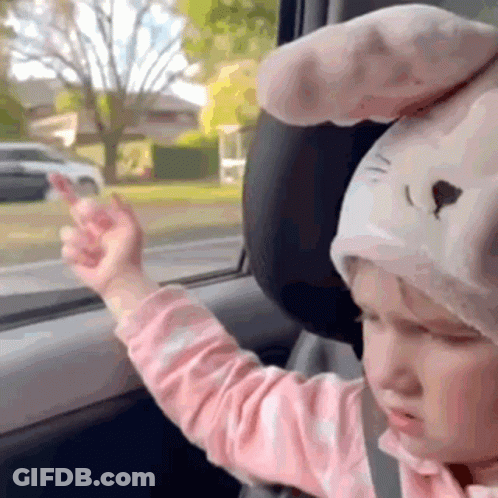 Little Girl In Bunny Hat Giving Middle Finger In Car GIF