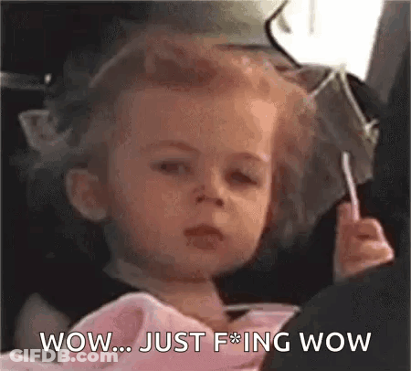Little Girl In Car Seat Holding Lollipop GIF