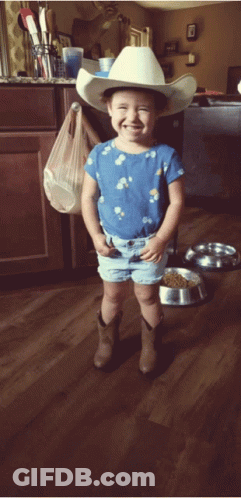 Little Girl In Cowboy Hat And Shorts Smiling GIF