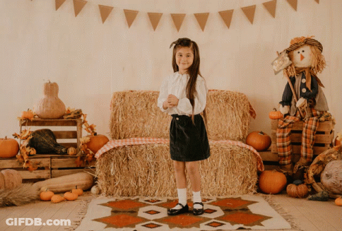 Little Girl In Front Of Hay Bale GIF
