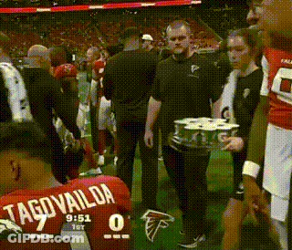 Little Girl In Green Dress Holding Wand Saying Hi GIF