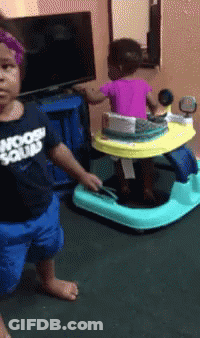 Little Girl In Moon Squad Shirt Next To Baby Walker GIF